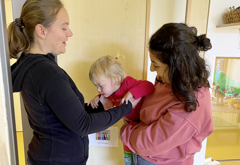 Zwei erwachsene Personen mit einem Kleinkind