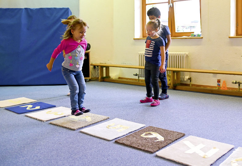 Kinder spielen ein Bewegungsspiel mit Zahlen