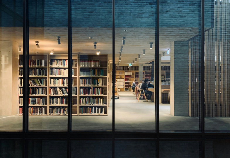 Blick durch ein großes Fenster in eine Bibliothek
