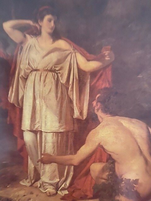 Nasikaa, in einem langen weißen Gewand und einem roten Manteltuch über den Schultern, steht vor Odysseus. Dieser kniet rechts zu ihren Füßen und schaut zu ihr hinauf.