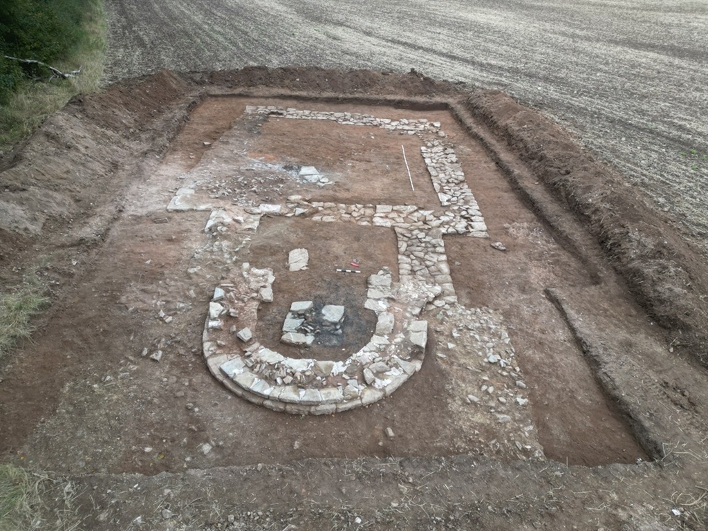 Freigelegter Grundriss der Mallerbacher Kapelle. DAs Altarfundament in der halbrunden Apsis weist deutliche Brandspuren auf.